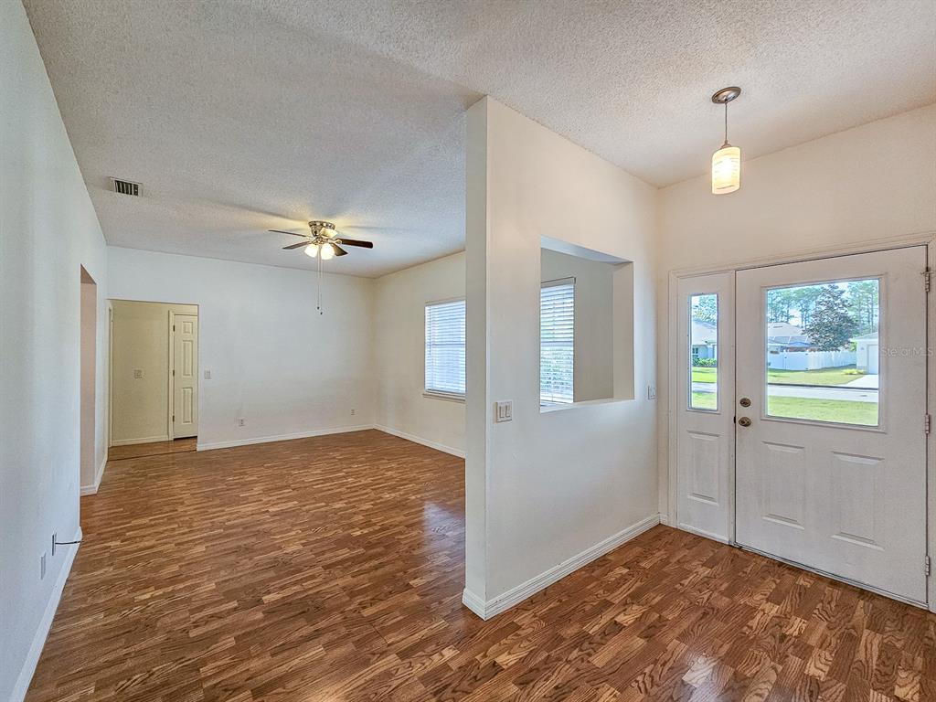 28 Botany Lane Palm Coast, FL 32137 - Photo 9 of 48 wooden floor in an empty room with a window