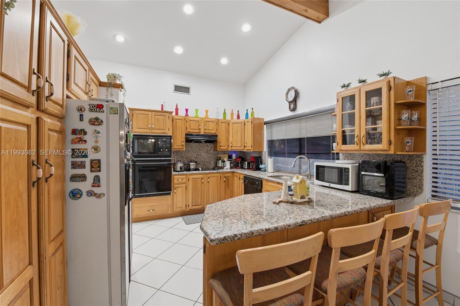 12702 Southwest 113th Lane Miami, FL 33186 - Photo 11 of 29 a kitchen with stainless steel appliances granite countertop a stove and a refrigerator