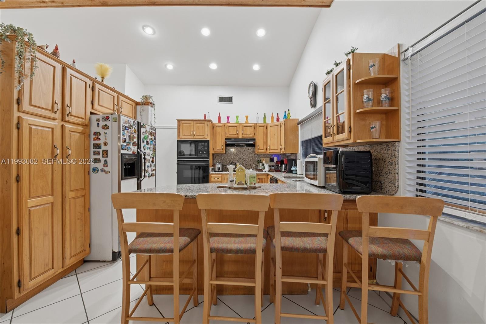 12702 Southwest 113th Lane Miami, FL 33186 - Photo 12 of 29 a large kitchen with a table and chairs