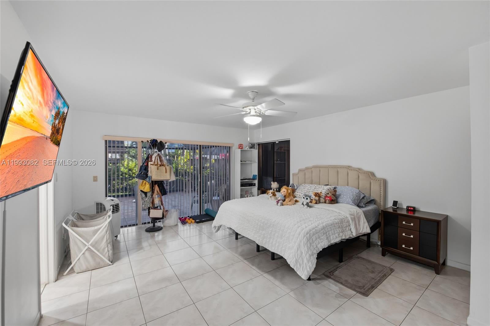 12702 Southwest 113th Lane Miami, FL 33186 - Photo 17 of 29 a bedroom with a bed and a chandelier