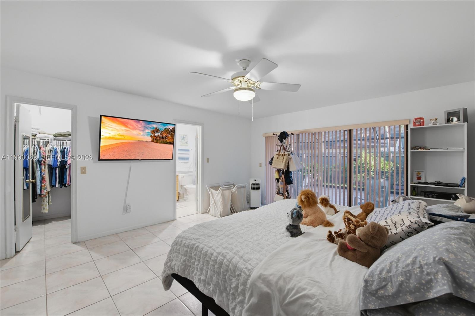 12702 Southwest 113th Lane Miami, FL 33186 - Photo 18 of 29 a bedroom with a bed and a flat screen tv