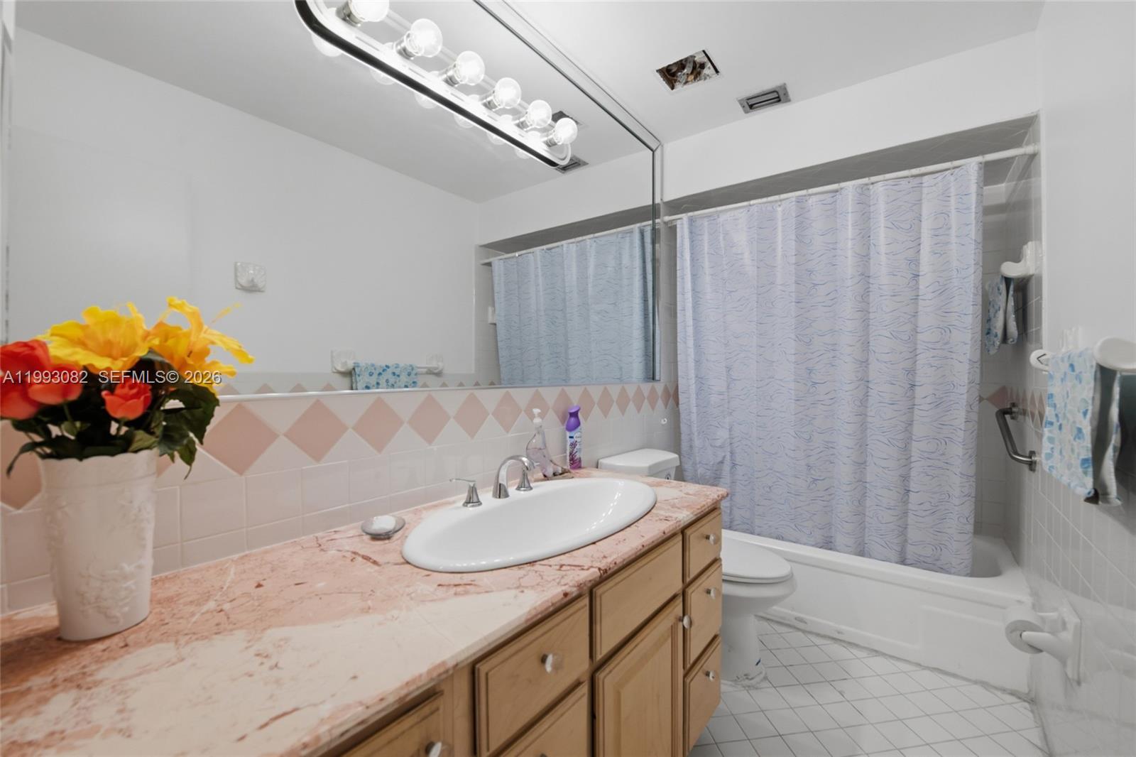 12702 Southwest 113th Lane Miami, FL 33186 - Photo 21 of 29 a bathroom with a sink a vanity and a mirror