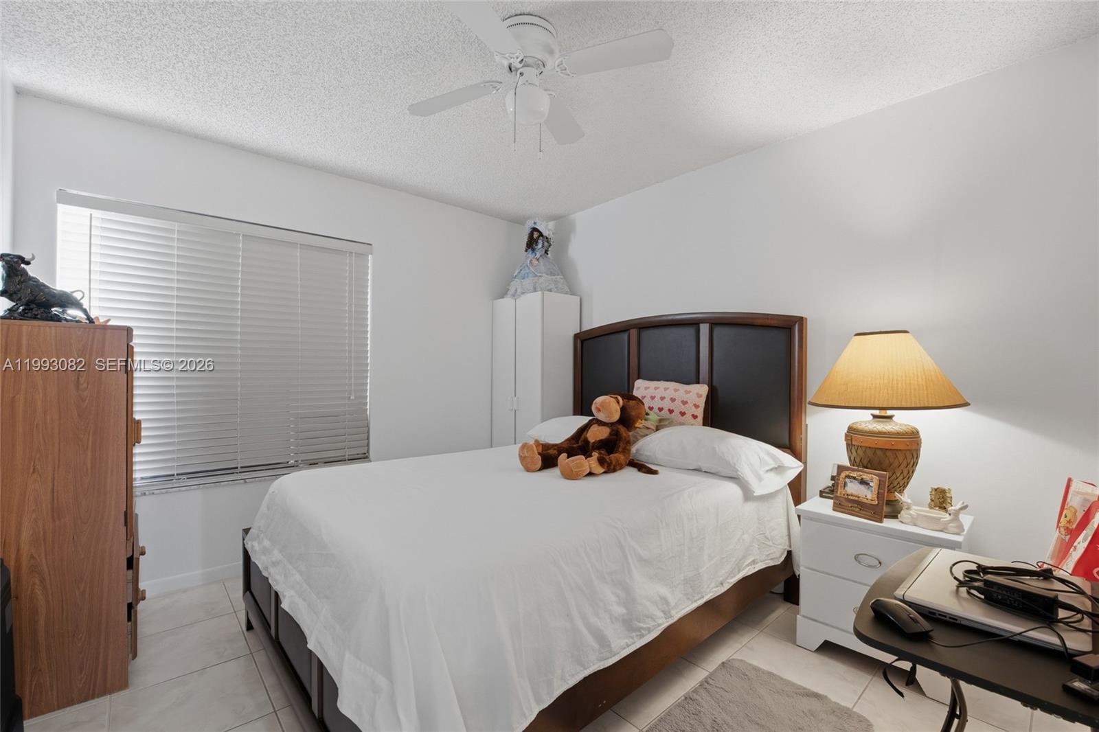 12702 Southwest 113th Lane Miami, FL 33186 - Photo 22 of 29 a bed room with a bed and a lamp