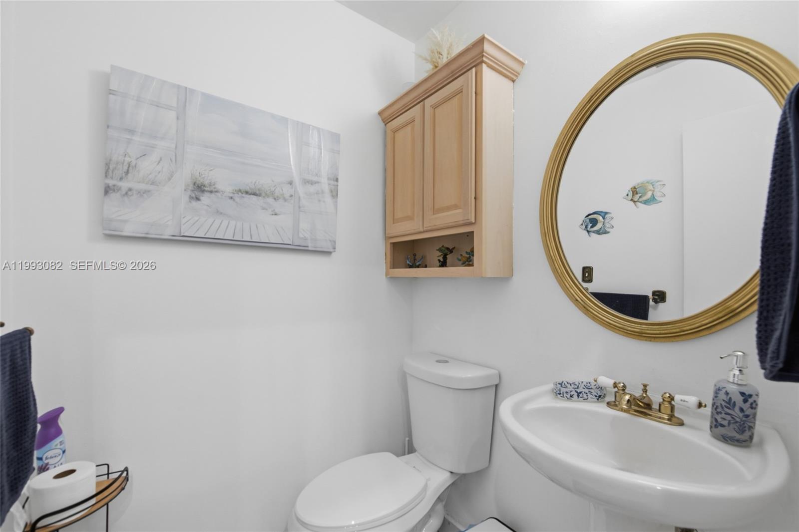 12702 Southwest 113th Lane Miami, FL 33186 - Photo 9 of 29 a bathroom with a toilet sink and mirror
