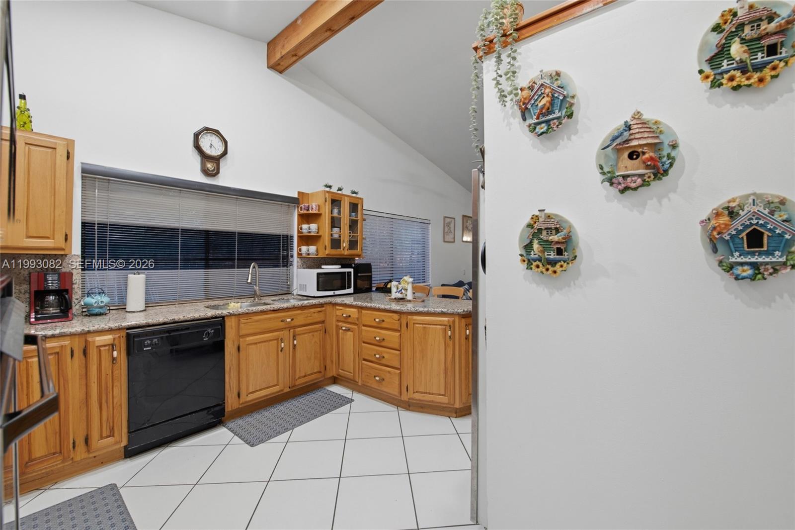12702 Southwest 113th Lane Miami, FL 33186 - Photo 10 of 29 a kitchen with a sink window and cabinets