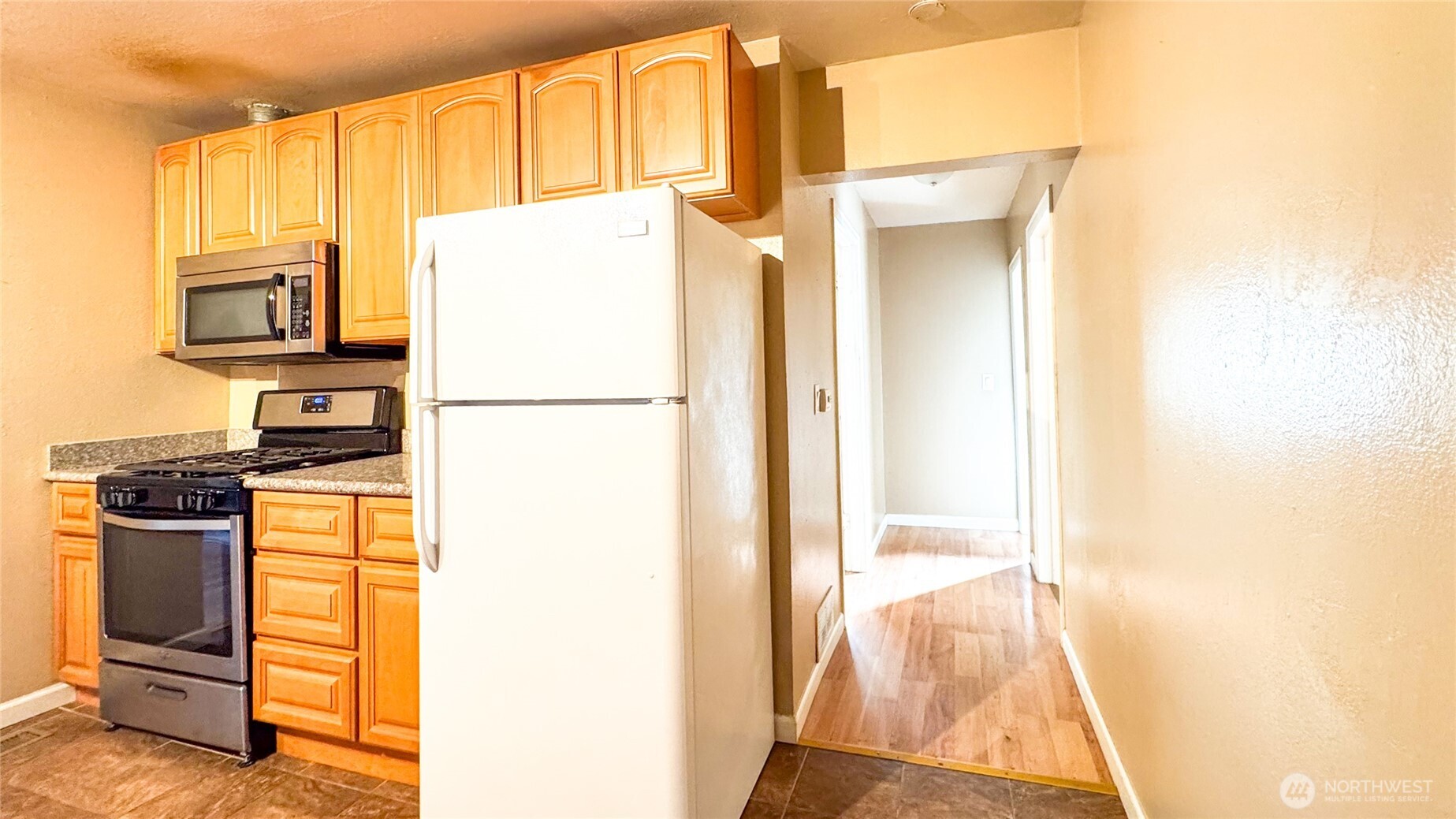 8825 South 132nd Street Renton, WA 98057 - Photo 8 of 13 a kitchen with a refrigerator and a stove