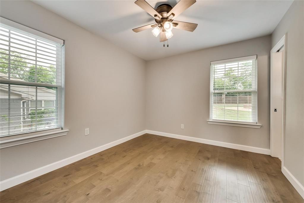 600 North 1st Street Midlothian, TX 76065 - Photo 14 of 21 a view of empty room with wooden floor and fan