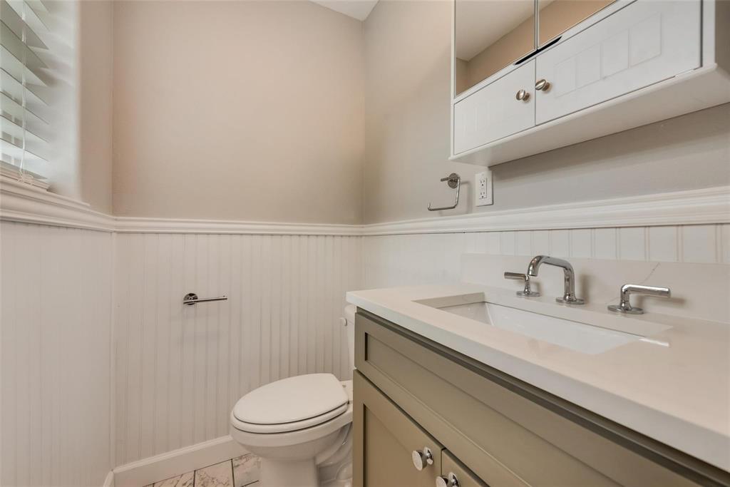 600 North 1st Street Midlothian, TX 76065 - Photo 15 of 21 a bathroom with a sink a toilet and a mirror