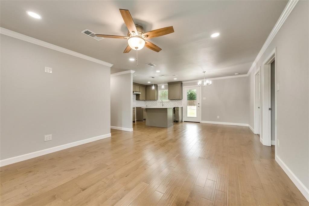 600 North 1st Street Midlothian, TX 76065 - Photo 3 of 21 an empty room with wooden floor and windows