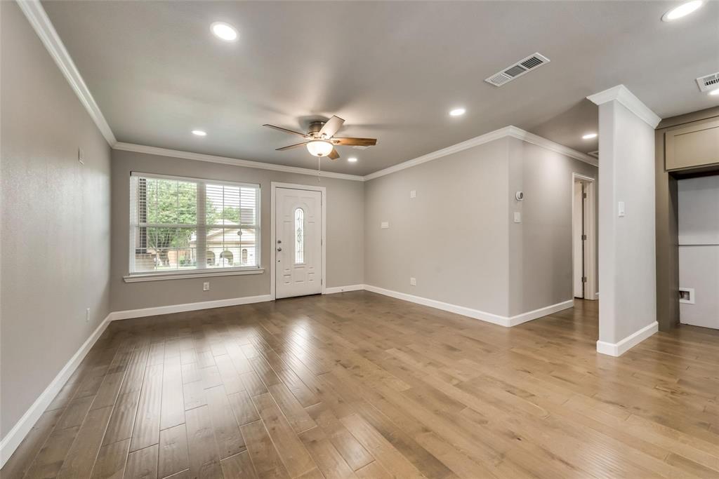 600 North 1st Street Midlothian, TX 76065 - Photo 4 of 21 an empty room with wooden floor and windows