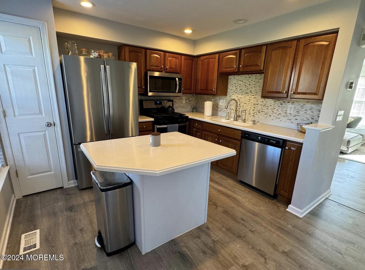 52 Saxton Road Farmingdale, NJ 07727 - Photo 30 of 52 a kitchen with stainless steel appliances a kitchen island hardwood floor sink and stove