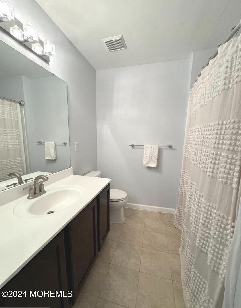 52 Saxton Road Farmingdale, NJ 07727 - Photo 43 of 52 a bathroom with a sink a toilet and a mirror