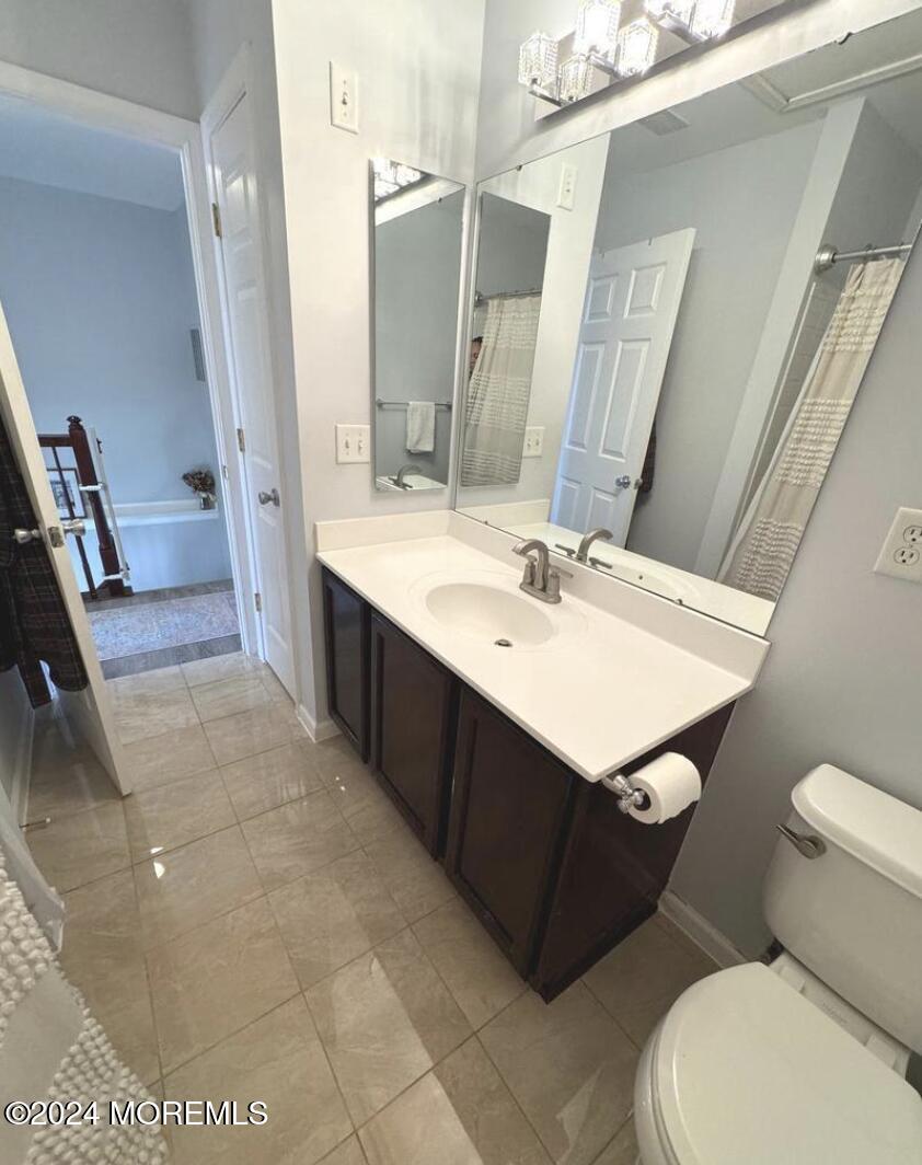 52 Saxton Road Farmingdale, NJ 07727 - Photo 44 of 52 a bathroom with a sink vanity mirror and toilet