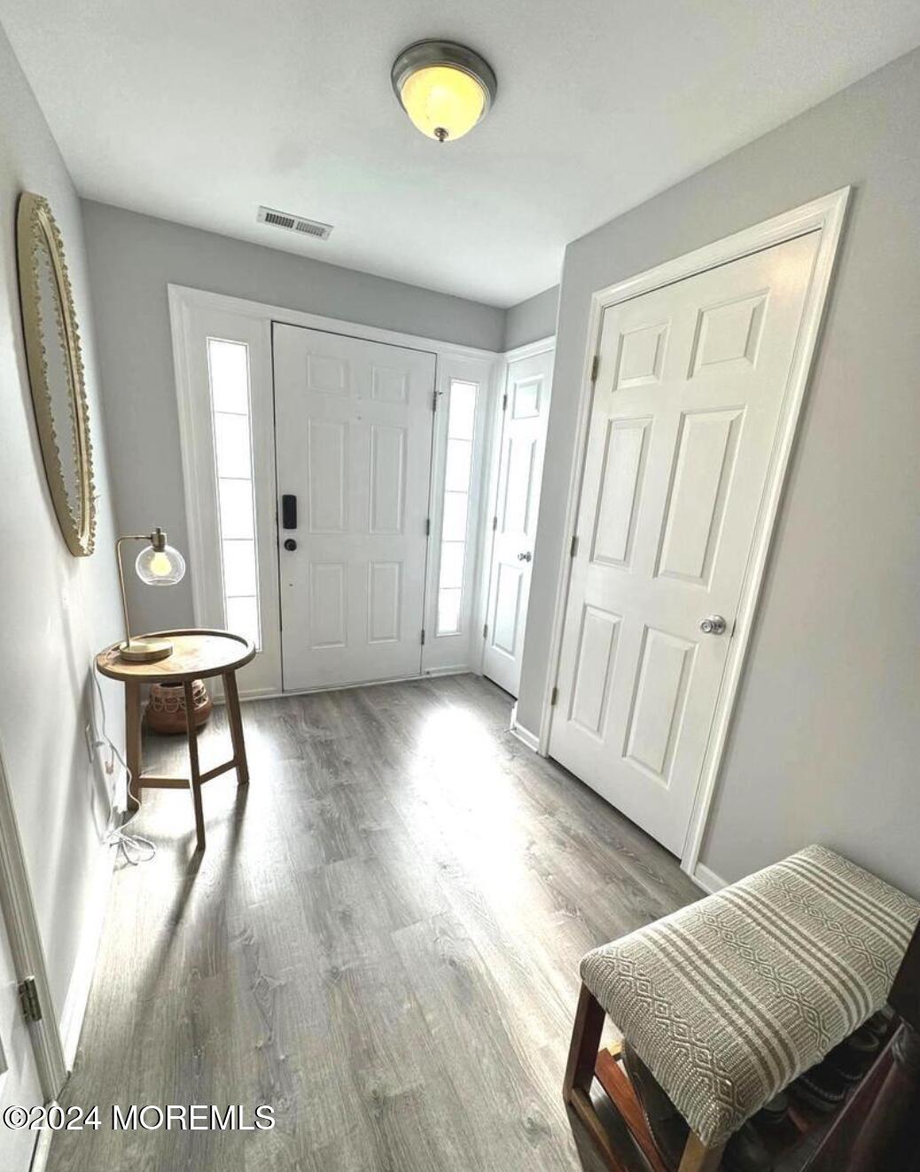 52 Saxton Road Farmingdale, NJ 07727 - Photo 5 of 52 a view of an empty room with wooden floor and a window