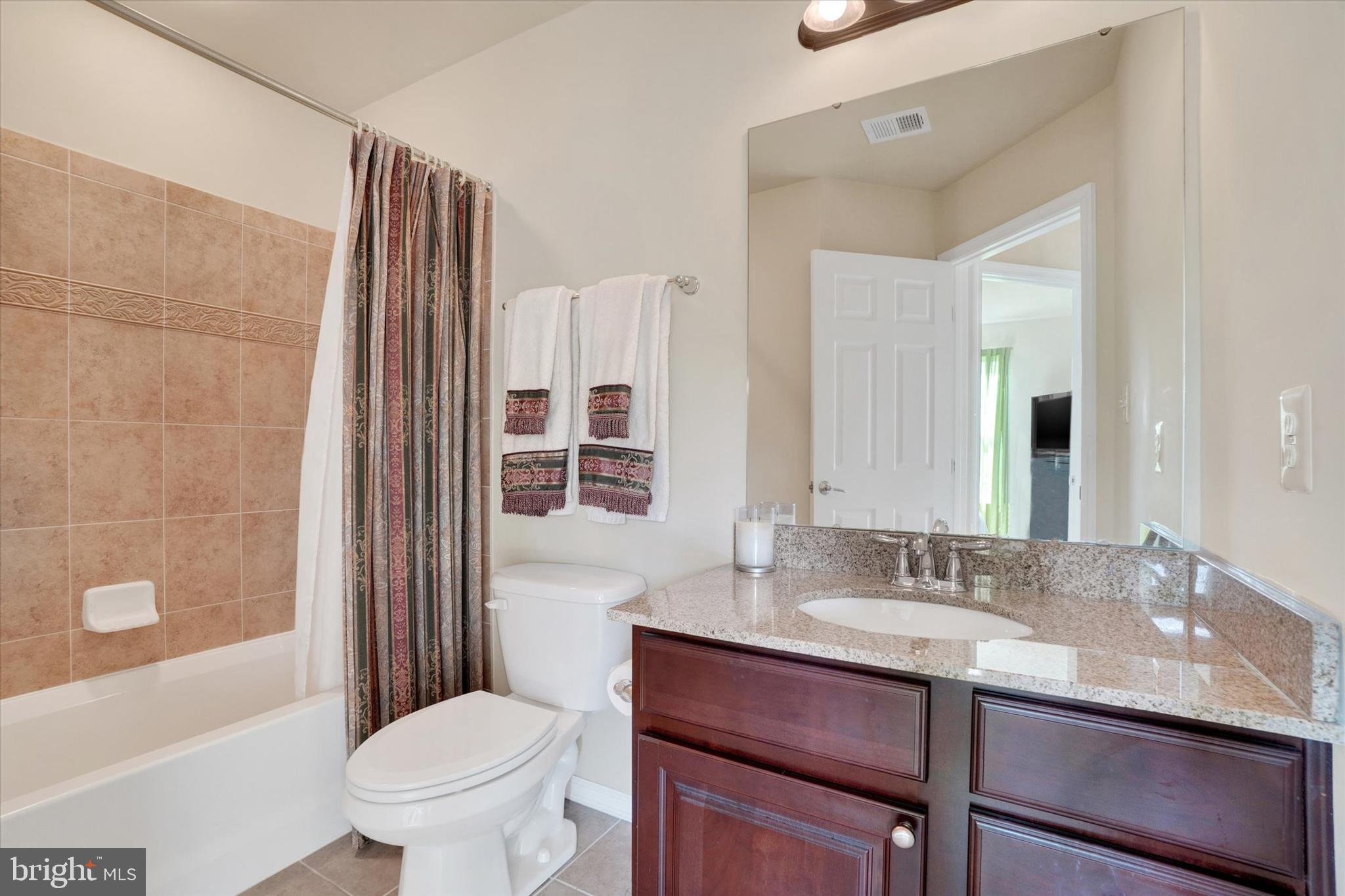 1269 Stonehaven Way, Unit 83 York, PA 17403 - Photo 18 of 28 a bathroom with a sink toilet a mirror and shower