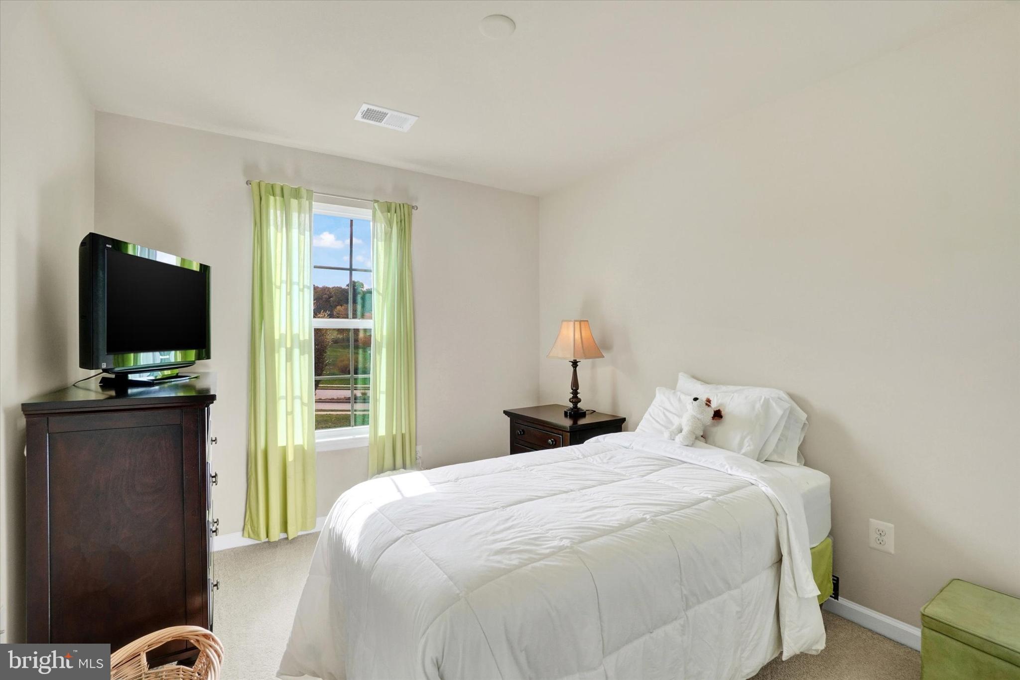 1269 Stonehaven Way, Unit 83 York, PA 17403 - Photo 19 of 28 a bedroom with a bed and a flat screen tv