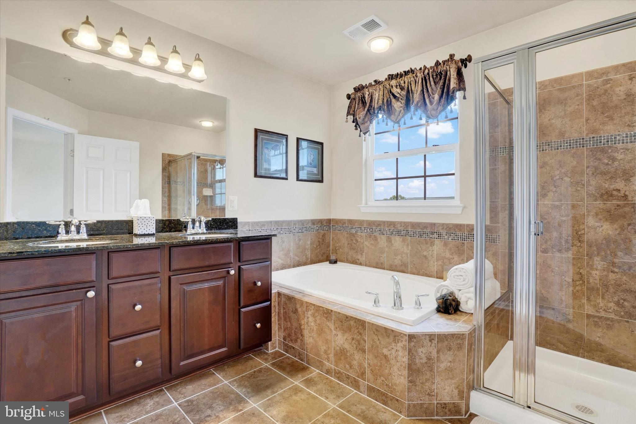 1269 Stonehaven Way, Unit 83 York, PA 17403 - Photo 22 of 28 a bathroom with a tub sink and mirror