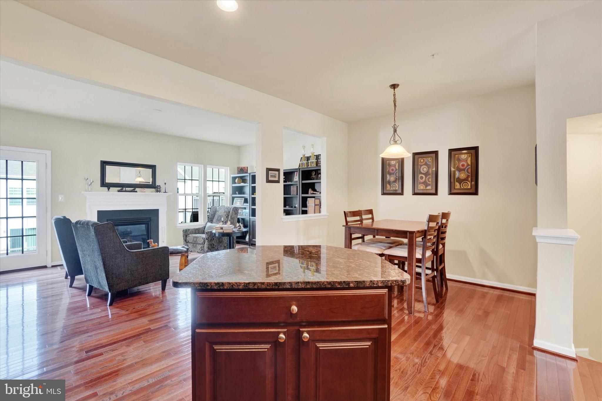 1269 Stonehaven Way, Unit 83 York, PA 17403 - Photo 10 of 28 a kitchen with granite countertop dining table chairs and wooden floor