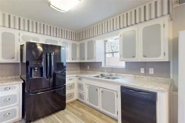 a kitchen with stainless steel appliances granite countertop a refrigerator sink and cabinets