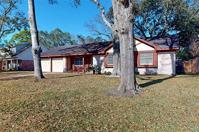 a view of a house with a tree in the yard