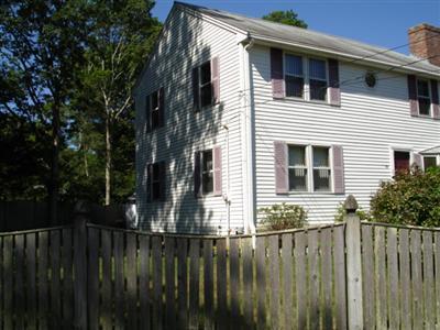 79 Harbor Hills Road Centerville, MA 02632 - Photo 3 of 7 a view of a house with backyard and wooden fence
