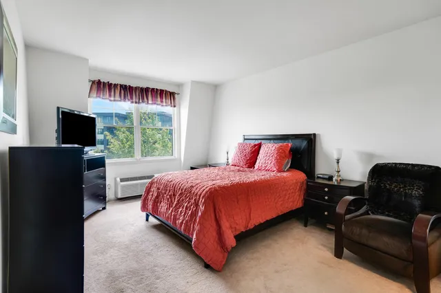 a bedroom with a bed and a television