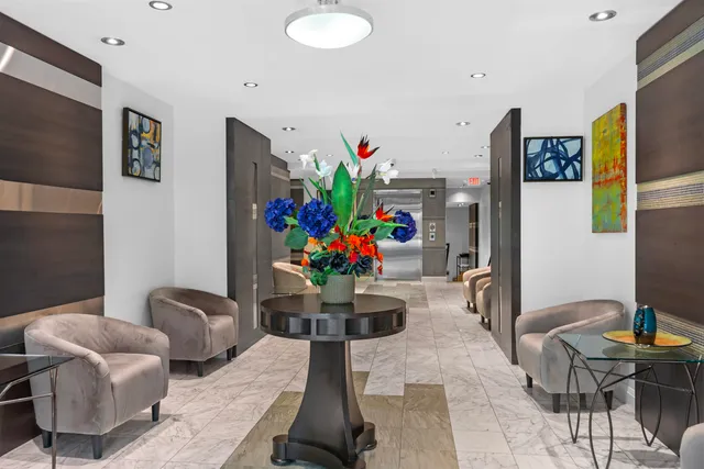 a living room with furniture and painting on the wall