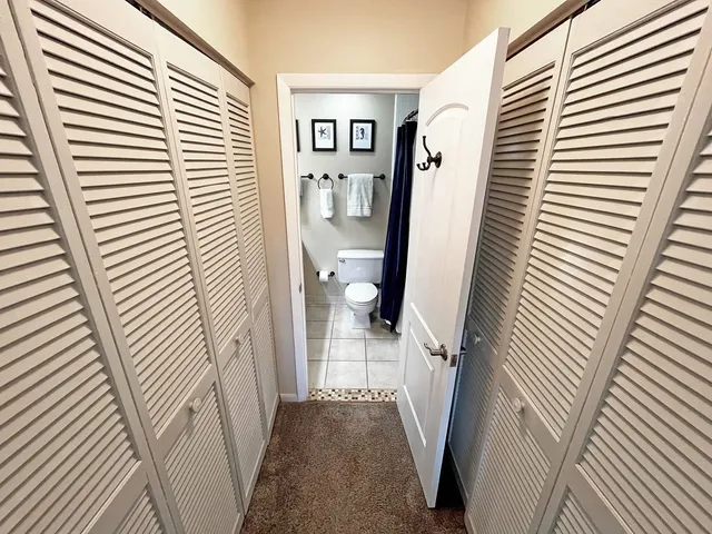 a view of a hallway with windows and stairs