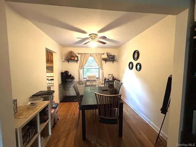 a view of a dining room with furniture and a chandelier