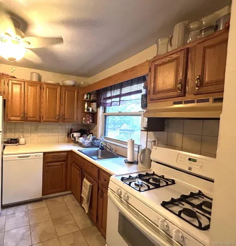 a kitchen with a stove a sink and a microwave