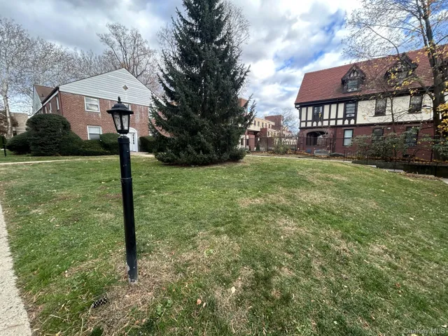 a front view of a house with yard and green space