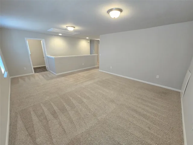 a view of an empty room and a window