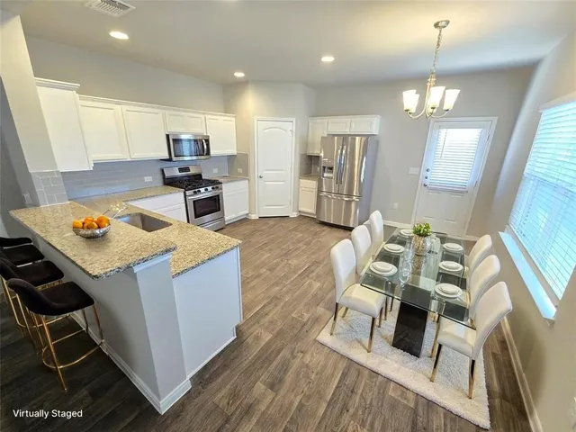 a living room with furniture and kitchen view