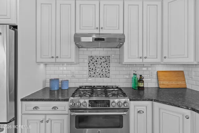 a stove top oven sitting inside of a kitchen