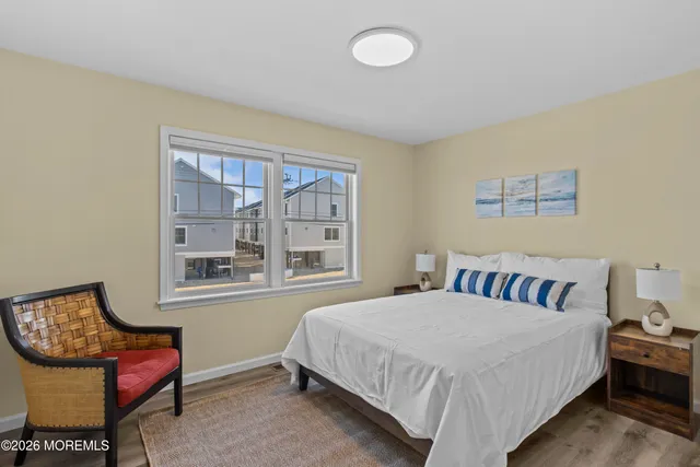 a bedroom with a bed chair and a window