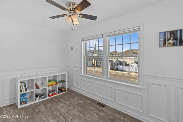a view of an empty room with window and cabinet