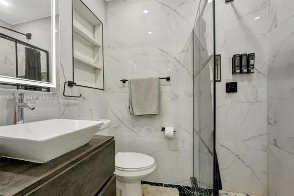 a bathroom with a glass shower door
