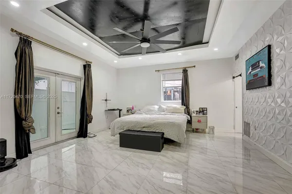a bathroom with a granite countertop double vanity sink a mirror and a bathtub