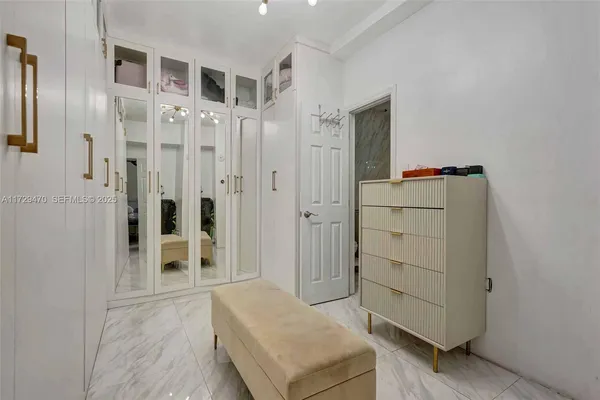 a bedroom with a bed and a tv on the dresser
