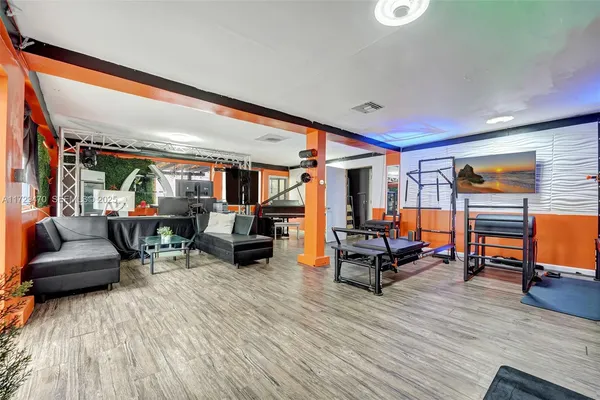 a living room with furniture and wooden floor