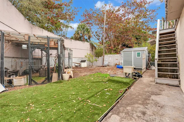 a kitchen with a stove a sink and a window