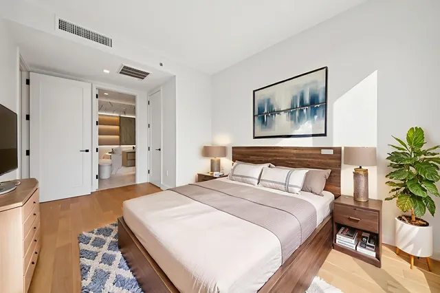 a bedroom with a bed and a flat screen tv