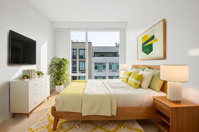 a bedroom with a bed and flat screen tv