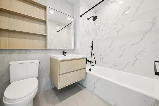 a bathroom with a sink a toilet and bathtub