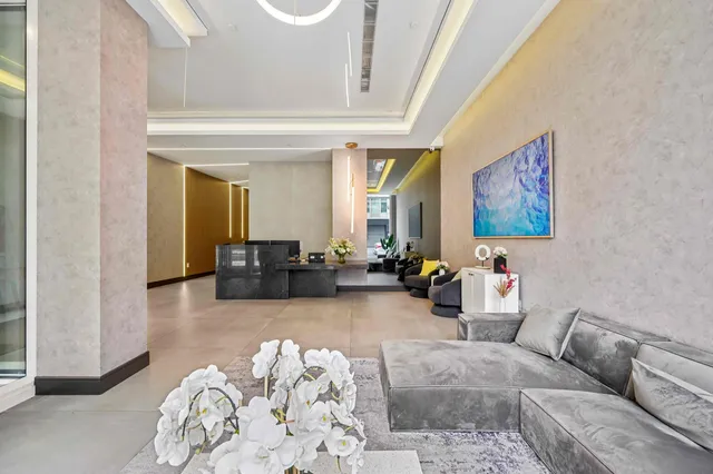 a living room with furniture and a chandelier