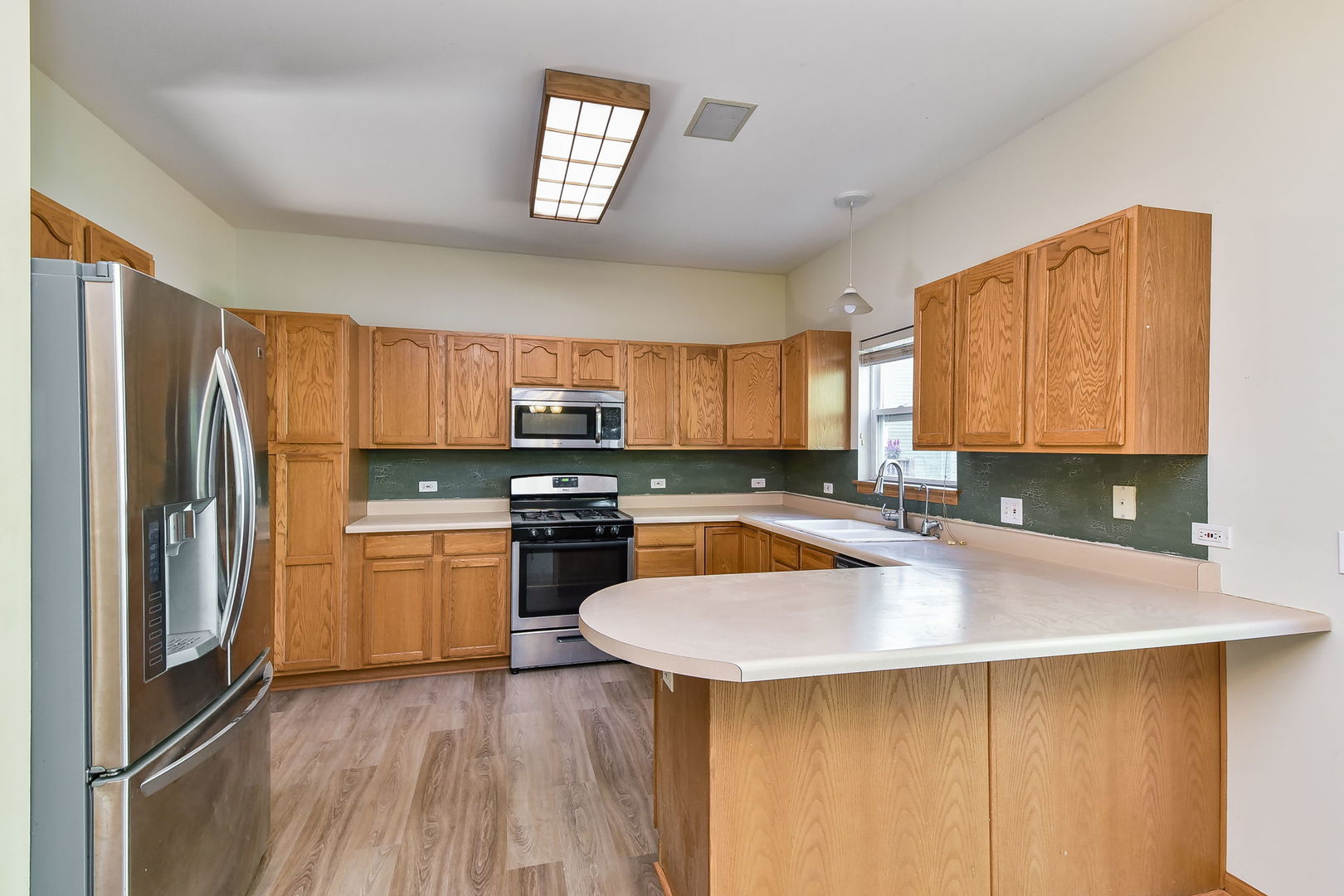 732 Robertson Road South Elgin, IL 60177 - Photo 5 of 37 a kitchen with stainless steel appliances granite countertop a sink a stove and refrigerator