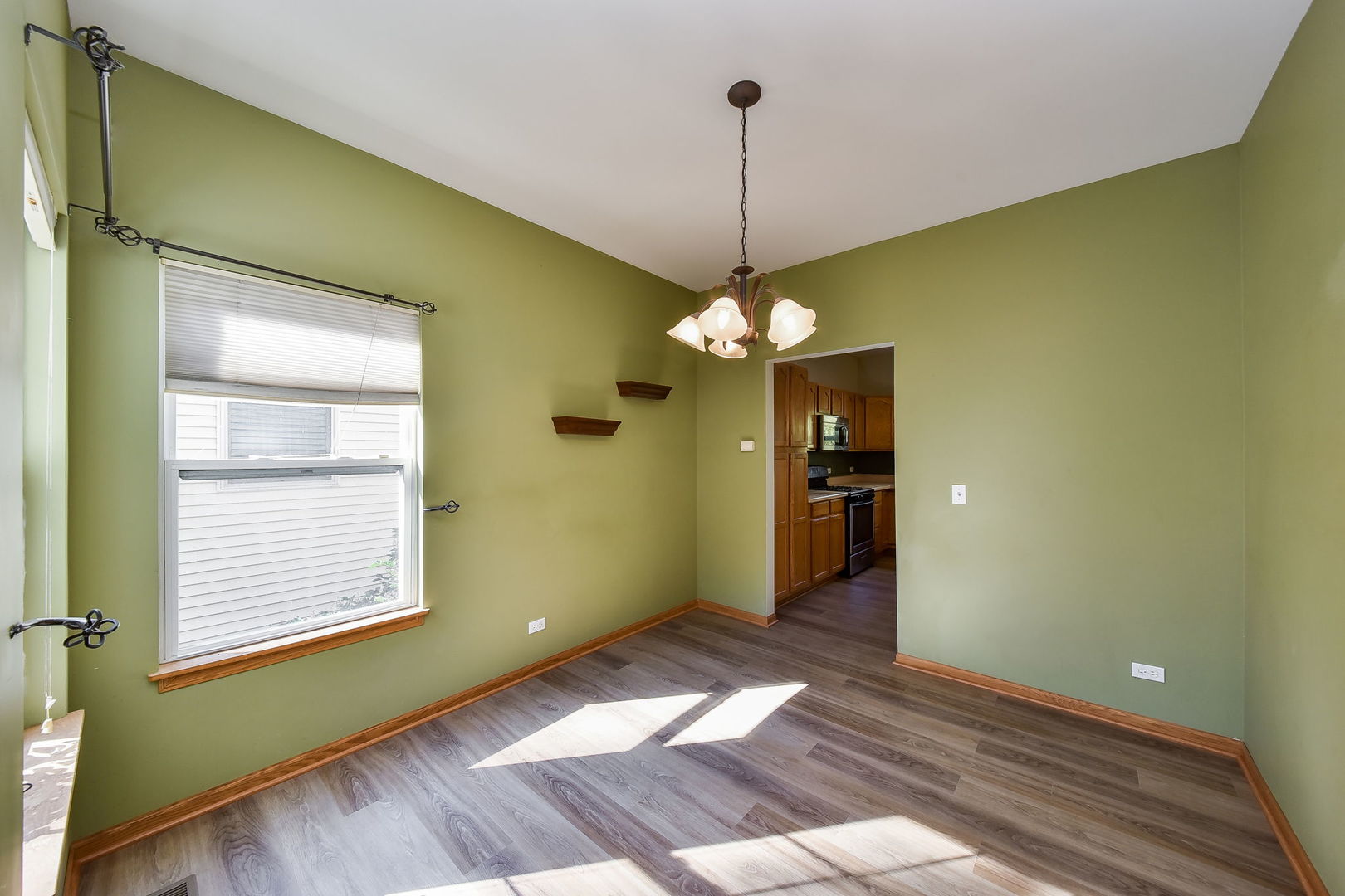 732 Robertson Road South Elgin, IL 60177 - Photo 7 of 37 a view of an empty room with window and chandelier
