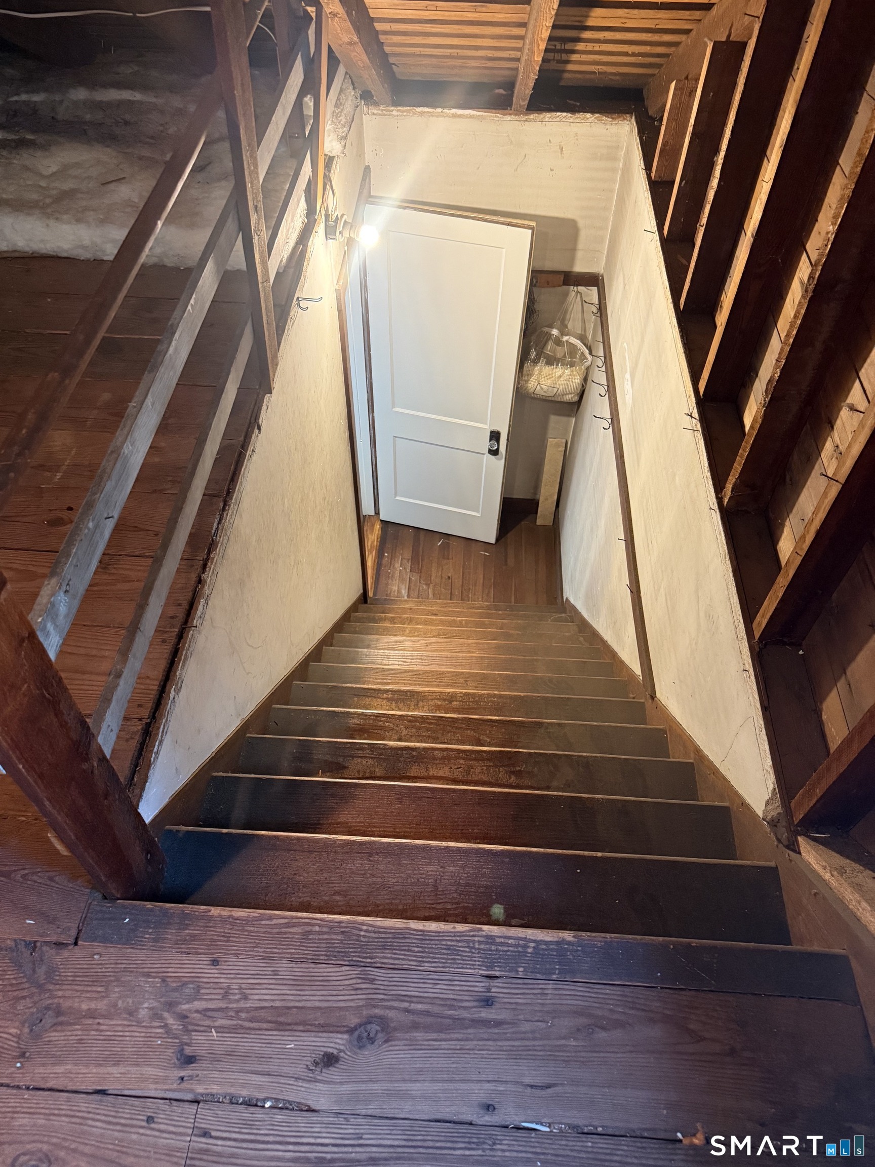94 Lancaster Road West Hartford, CT 06119 - Photo 22 of 25 extra wide staircase to exposed original attic with vintage rough sawn cedar beams
