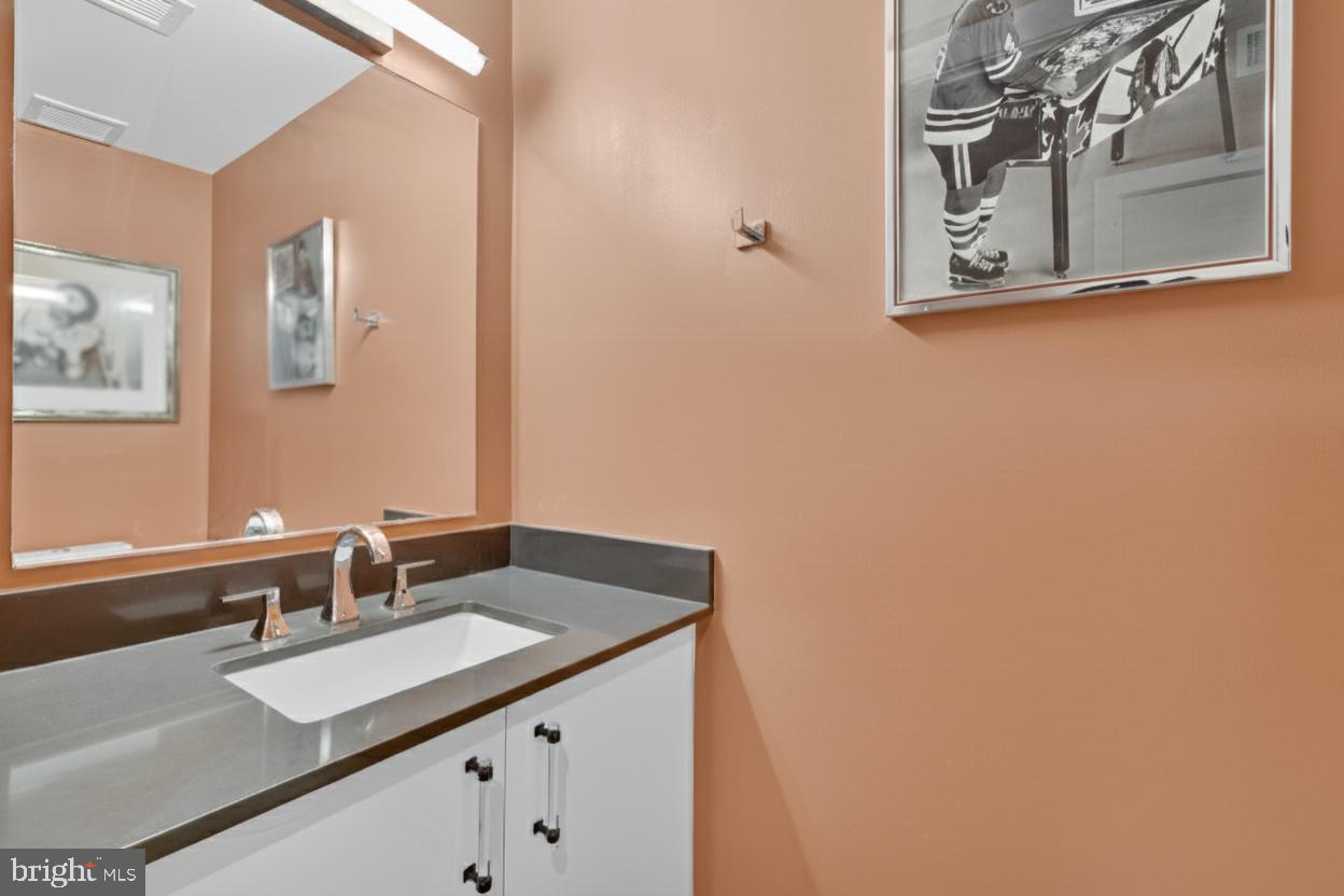 88 V Street Southwest, Unit 313 Washington, DC 20024 - Photo 17 of 38 a bathroom with a sink and a mirror