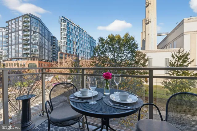 a balcony with table and chairs